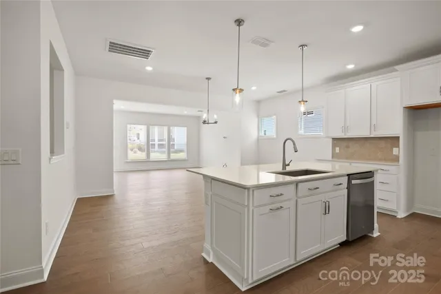 a kitchen with a sink window and cabinets