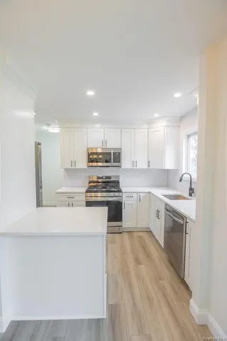 a kitchen with a white cabinets stove and sink