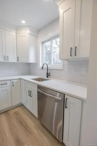 a kitchen with a sink cabinets and window