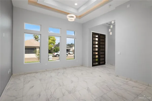 an empty room with windows and closet