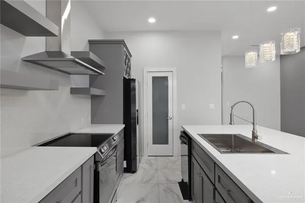 a kitchen that has a sink and a stove
