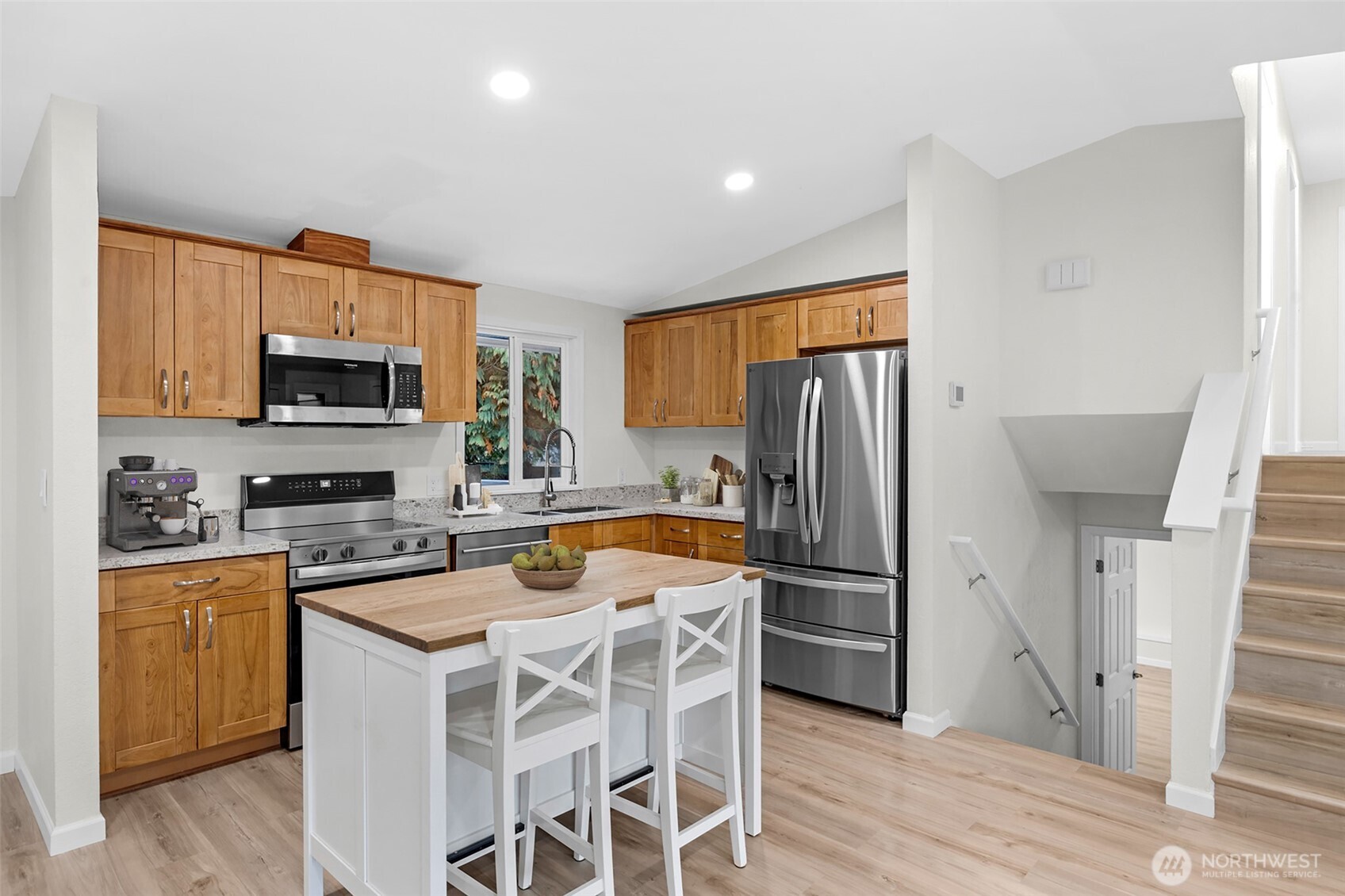 2400 177th Street Southeast Bothell, WA 98012 - Photo 6 of 29 a kitchen with granite countertop a refrigerator stove top oven and sink