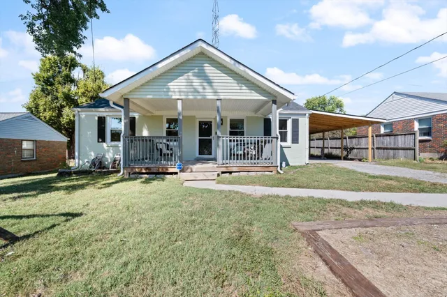 a view of a house with swimming pool and porch