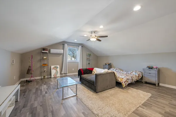 a bedroom with furniture and wooden floor