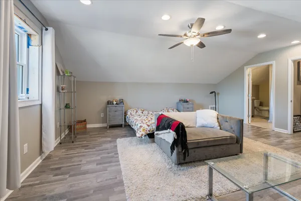 a bedroom with furniture and white walls