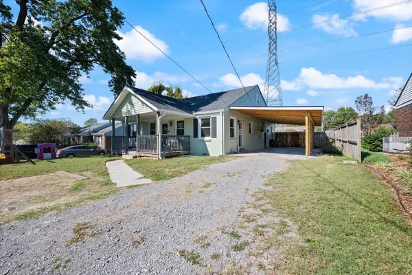 a view of a house with a yard and potted plants