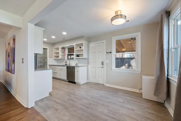 a view of a kitchen with refrigerator and windows