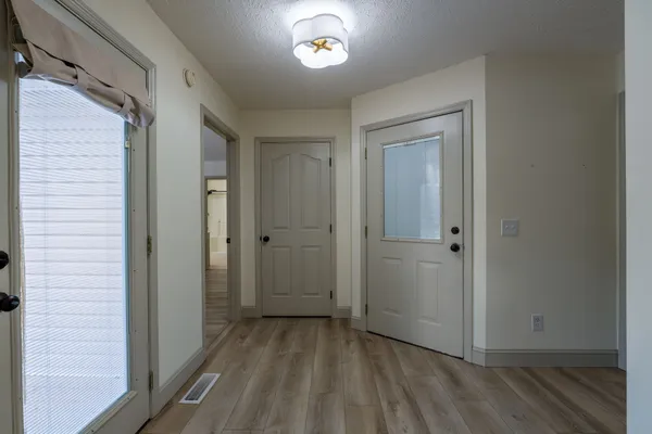 a view of a hallway with wooden floor