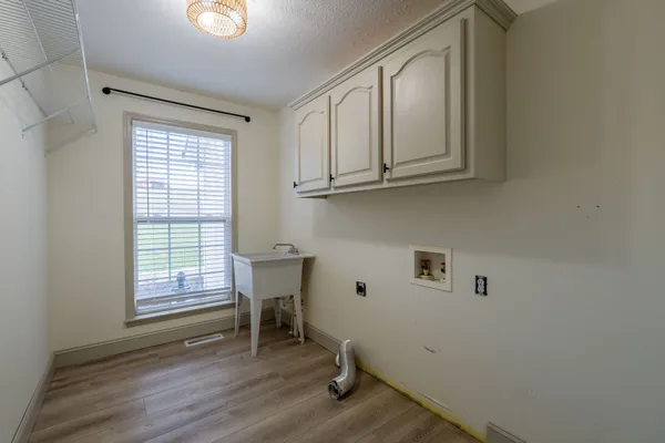 a view of room with window and wooden floor