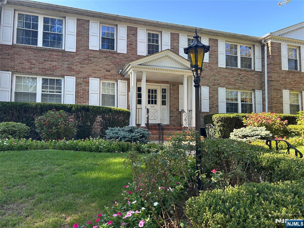 374 East Ridgewood Avenue, Unit 6 Ridgewood, NJ 07450 - Photo 2 of 2 a front view of a house with a yard