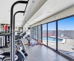 555 Northeast 30th Street, Unit 203 Miami, FL 33137 - Photo 16 of 23 a view of a room with gym equipment