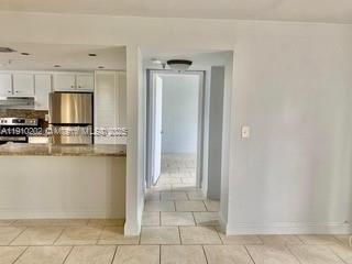 555 Northeast 30th Street, Unit 203 Miami, FL 33137 - Photo 7 of 23 a view of a kitchen with wooden floor and a sink