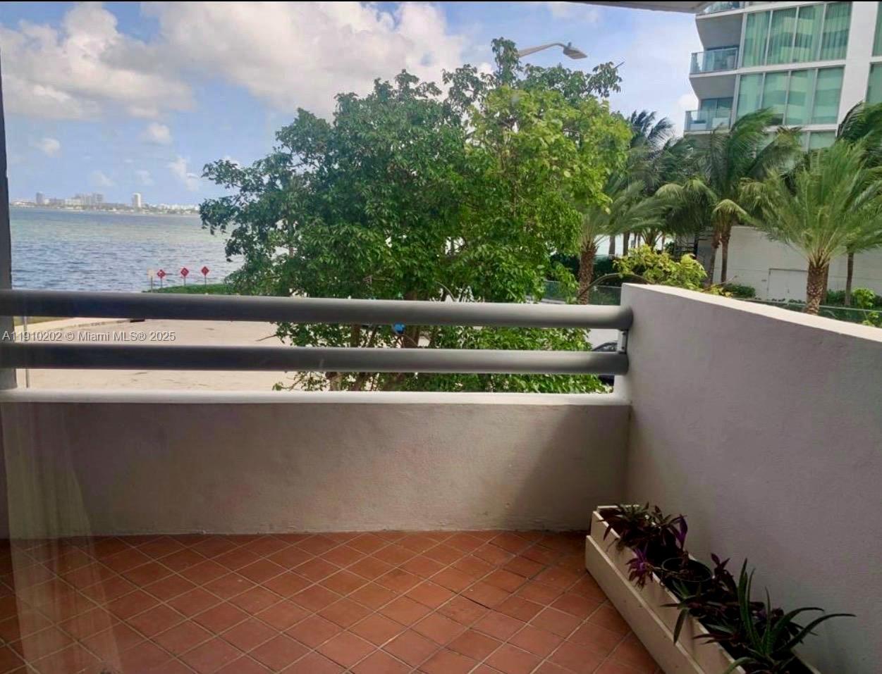 555 Northeast 30th Street, Unit 203 Miami, FL 33137 - Photo 10 of 23 a view of outdoor space with swimming pool and trees in the background