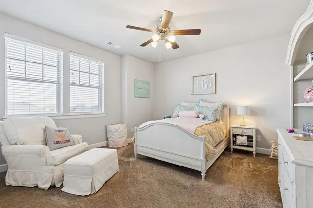 a spacious bedroom with a bed and a couch