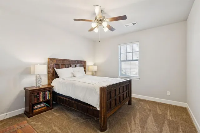 a bed sitting in a bedroom next to a window