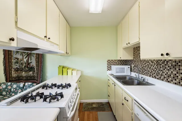 a kitchen with a sink and a stove top oven
