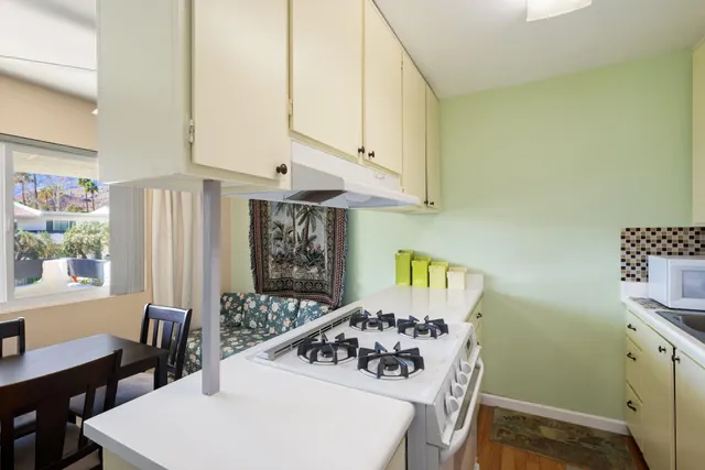 a kitchen with a sink a stove and a refrigerator