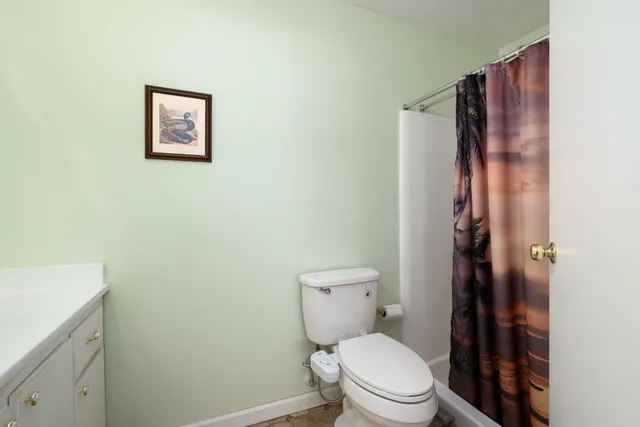 a white toilet sitting next to a bathroom sink