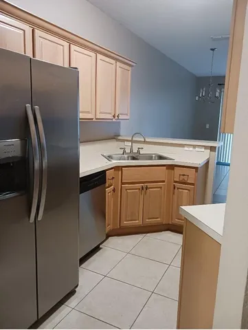 a kitchen with stainless steel appliances a refrigerator sink and cabinets