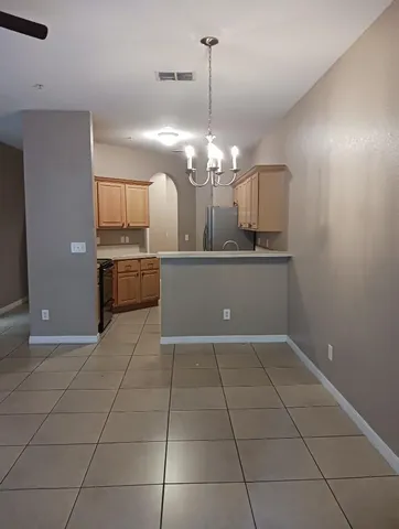 a view of a kitchen with a sink stainless steel appliances and cabinets