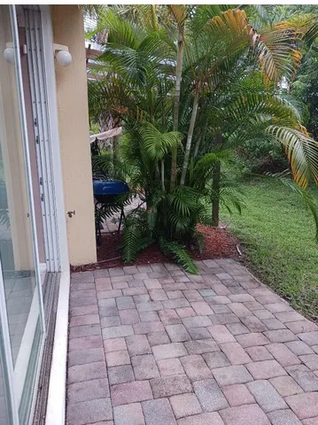 a view of a back yard from a corridor