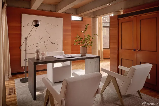 a view of a hallway with wooden floor and windows