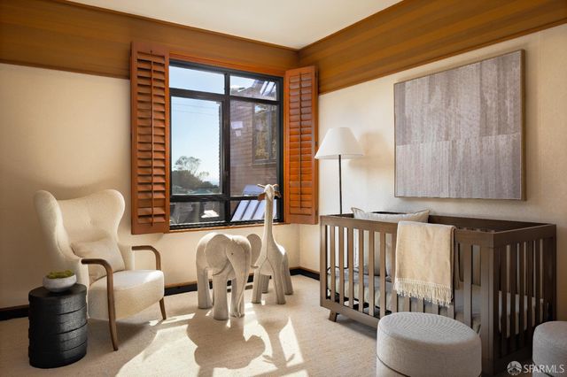 a bedroom with two beds and a large window