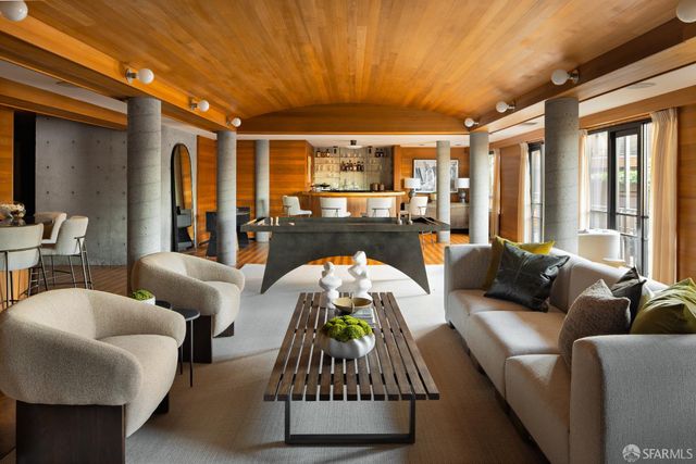 a dining room with chairs and wooden floor