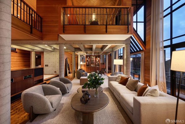 a living room with furniture a fireplace and a potted plant