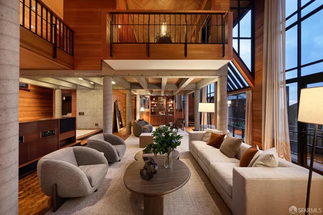 a living room with furniture a fireplace and a potted plant