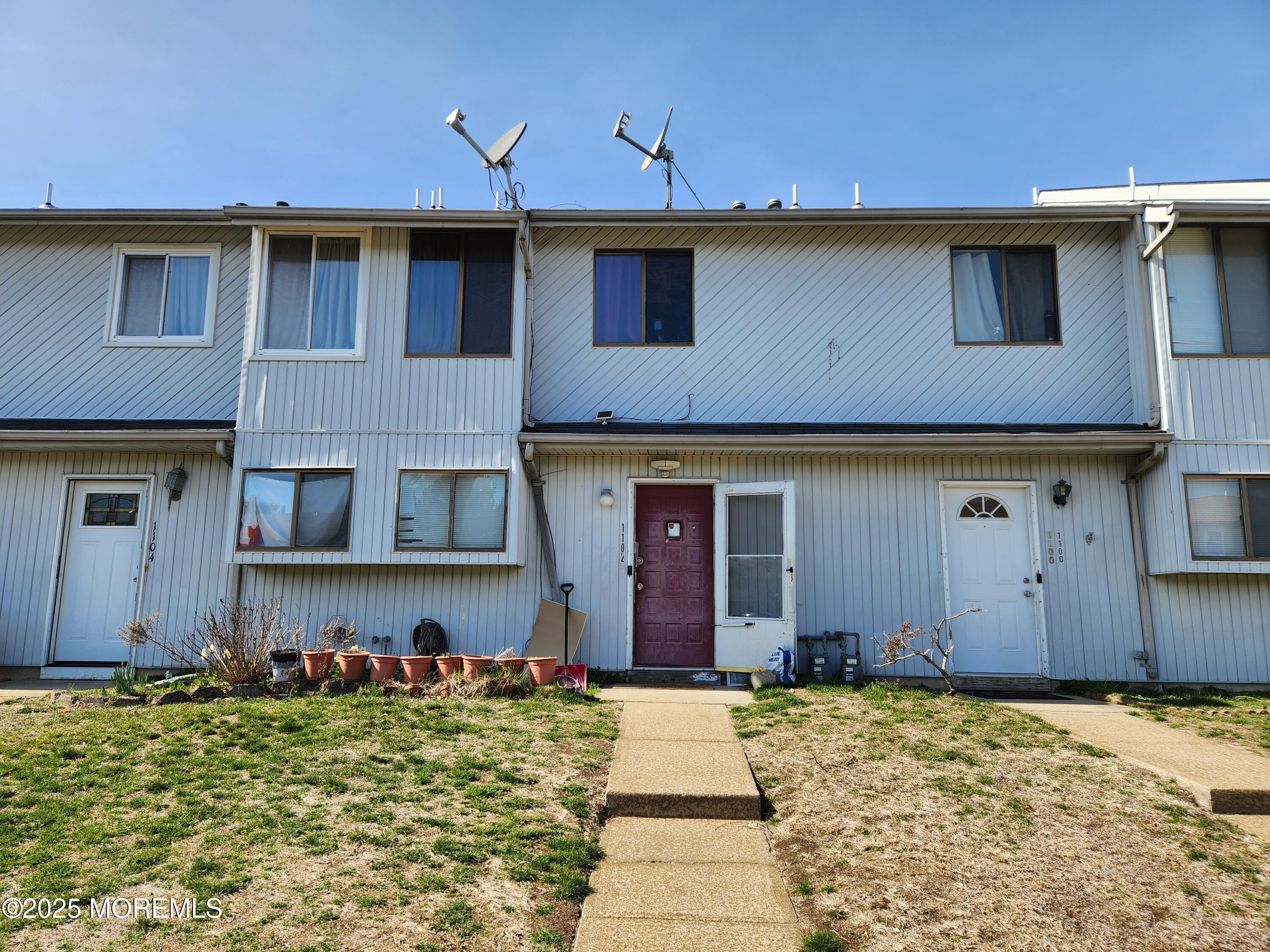 1102 Sawmill Road, Unit 99 Brick, NJ 08724 - Photo 1 of 13 a front view of a house with a yard