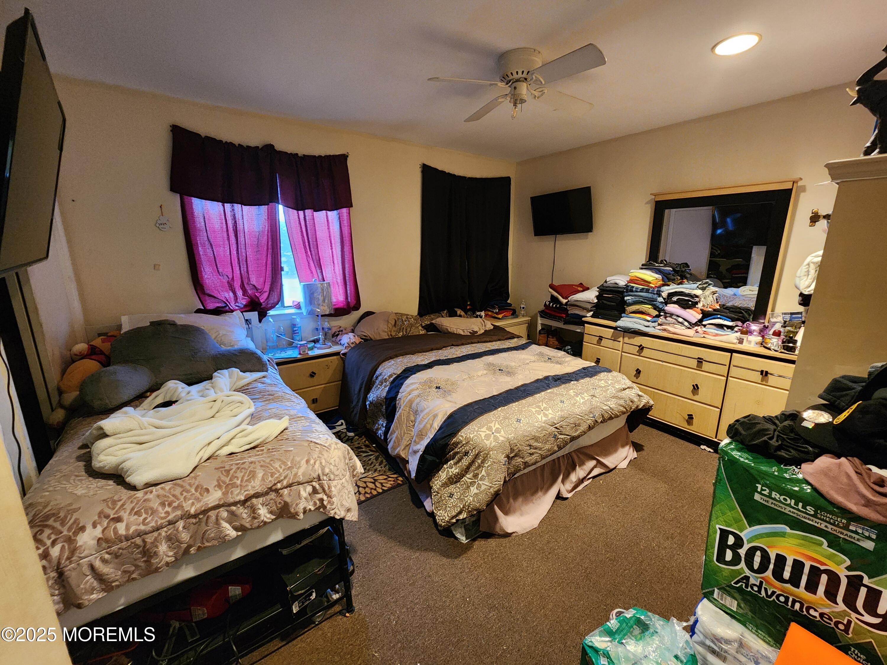 1102 Sawmill Road, Unit 99 Brick, NJ 08724 - Photo 11 of 13 a bedroom with two beds and a flat screen tv