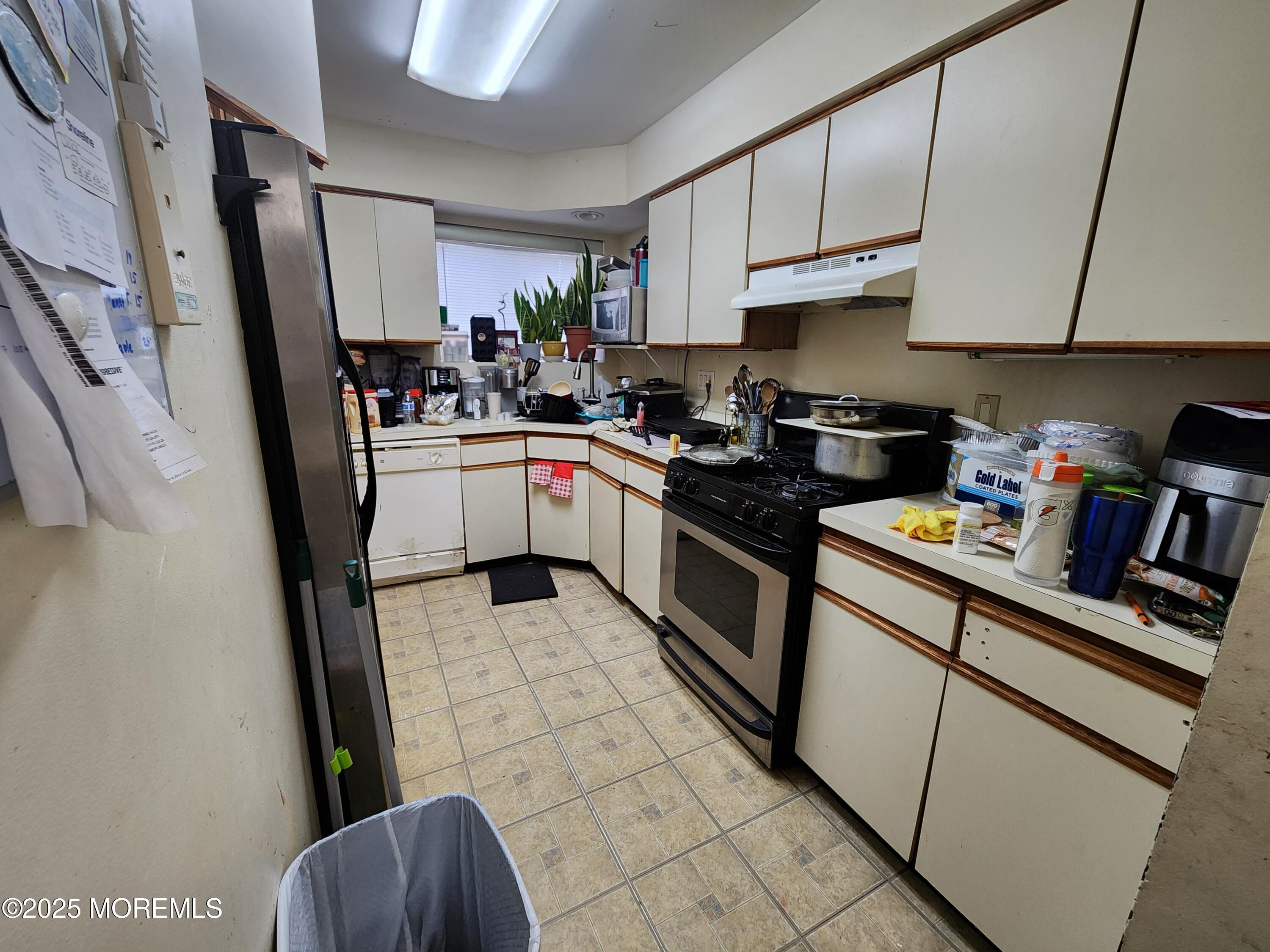 1102 Sawmill Road, Unit 99 Brick, NJ 08724 - Photo 4 of 13 a kitchen with stainless steel appliances a refrigerator a sink a stove a microwave and cabinets