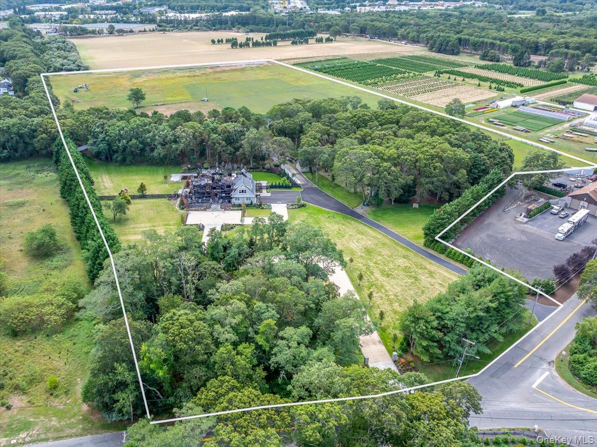 1535 Middle Road Calverton, NY 11933 - Photo 1 of 1 Overview of rural landscape with property boundaries highlighted and a tree filled landscape