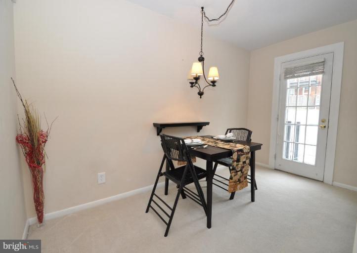 4620 28th Road South, Unit B Arlington, VA 22206 - Photo 12 of 18 a view of a dining room with furniture and a chandelier