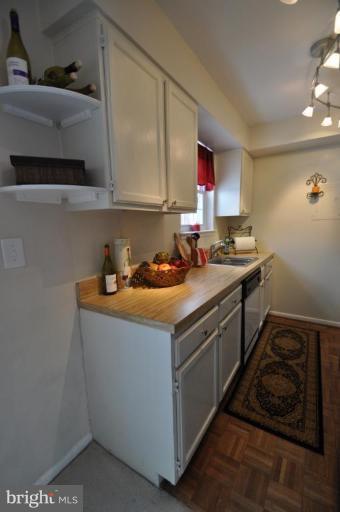 4620 28th Road South, Unit B Arlington, VA 22206 - Photo 4 of 18 a kitchen with stainless steel appliances granite countertop a sink stove and cabinets