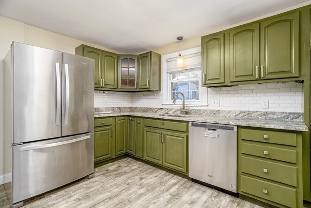 a kitchen with granite countertop stainless steel appliances and refrigerator