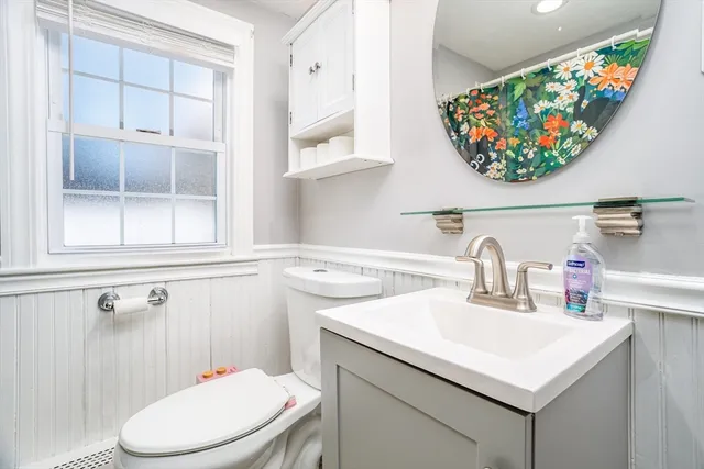 a bathroom with a sink a toilet and a window