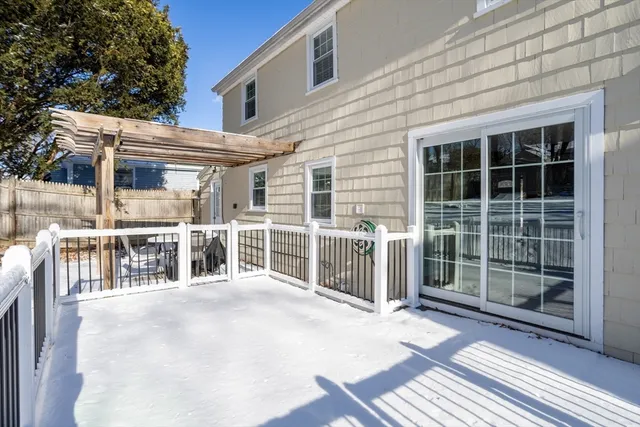 a view of a balcony with a floor to ceiling window and wooden fence