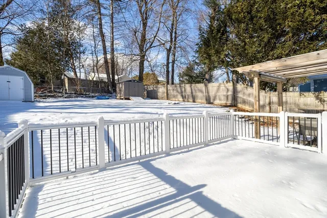 a view of a house with a wooden fence