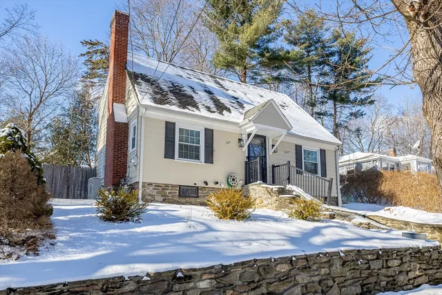 a view of a white house with a yard