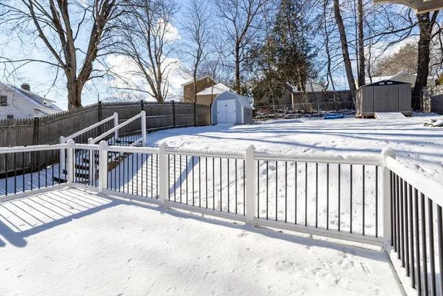 a view of a house with a wooden fence