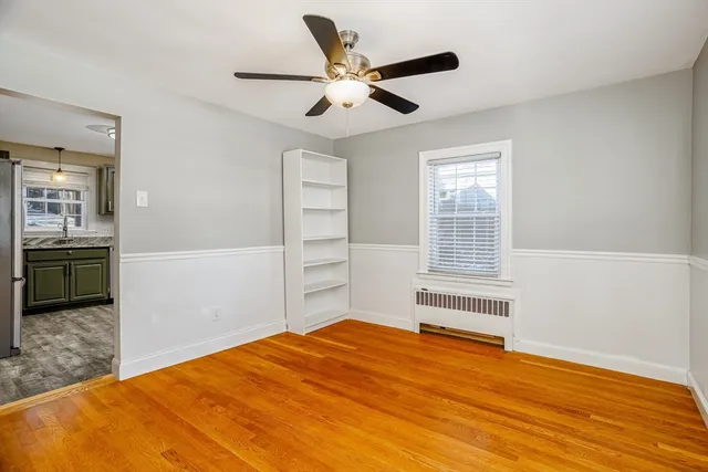 a bedroom with a bed and a ceiling fan