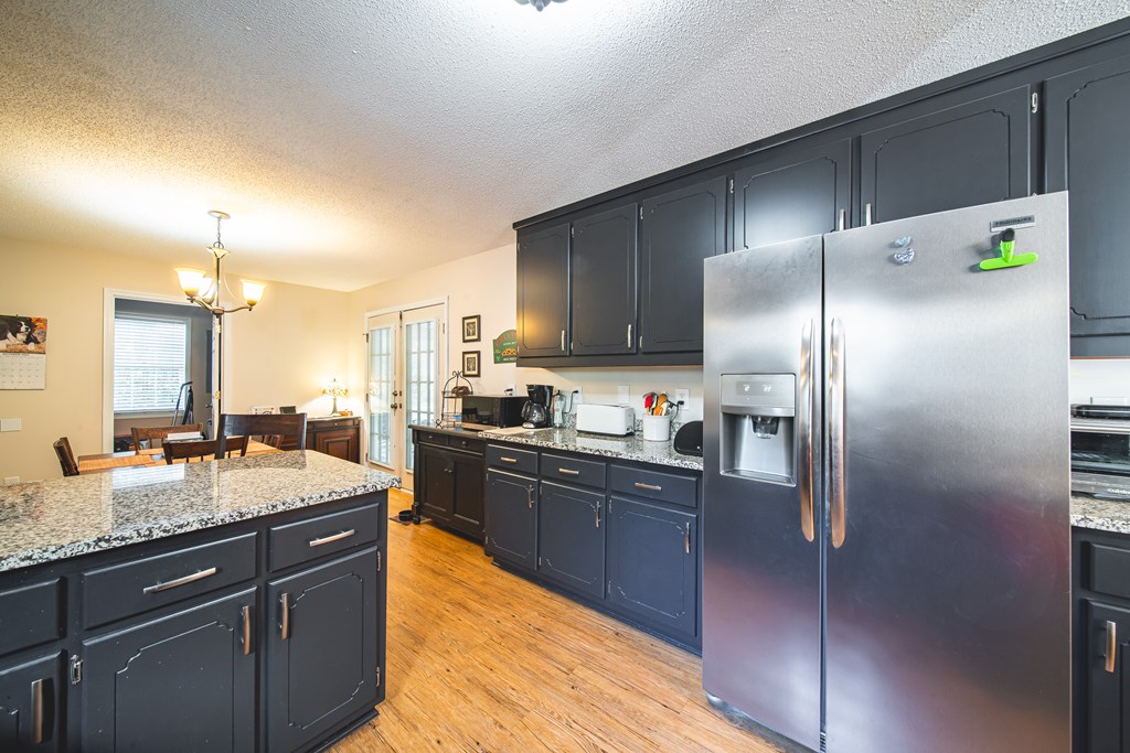 200 Lake Amah Lee Road Hampton, GA 30228 - Photo 14 of 29 a kitchen with stainless steel appliances granite countertop a sink a stove and refrigerator