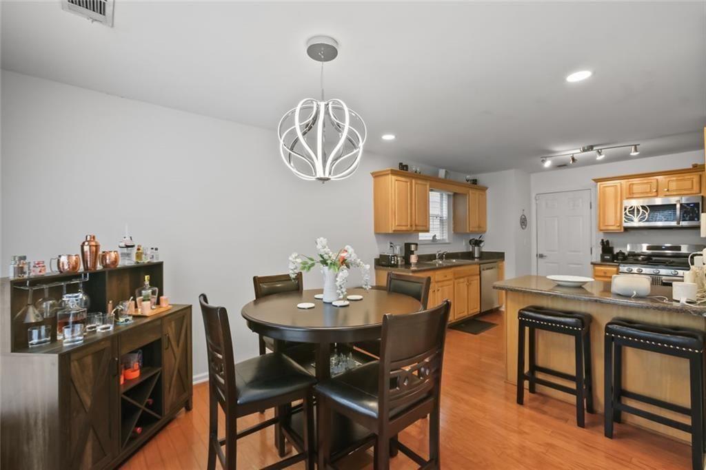1464 Gates Circle Southeast Atlanta, GA 30316 - Photo 11 of 26 a view of a dining room with furniture and a chandelier