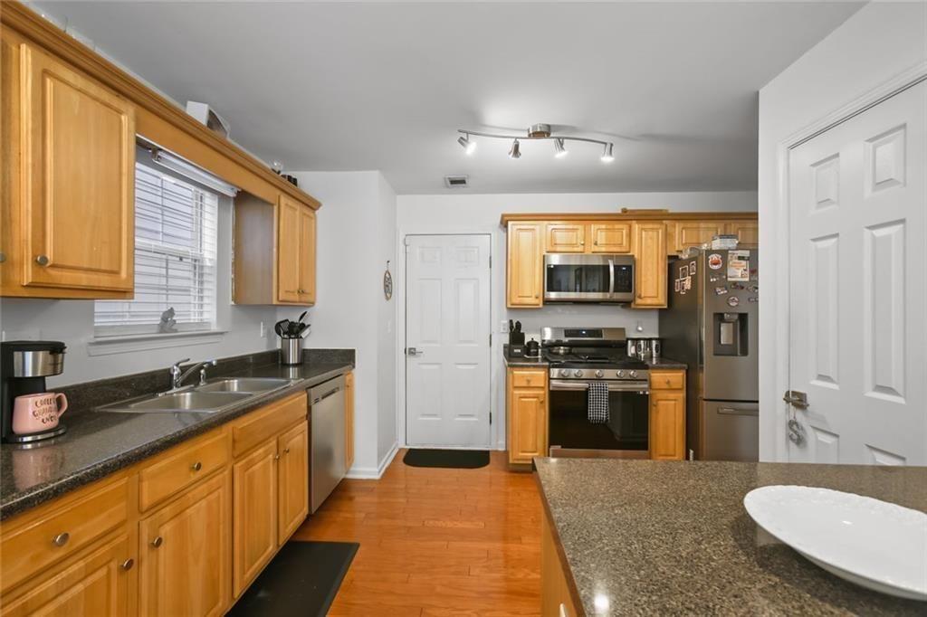 1464 Gates Circle Southeast Atlanta, GA 30316 - Photo 15 of 26 a large kitchen with stainless steel appliances granite countertop a sink dishwasher stove and refrigerator