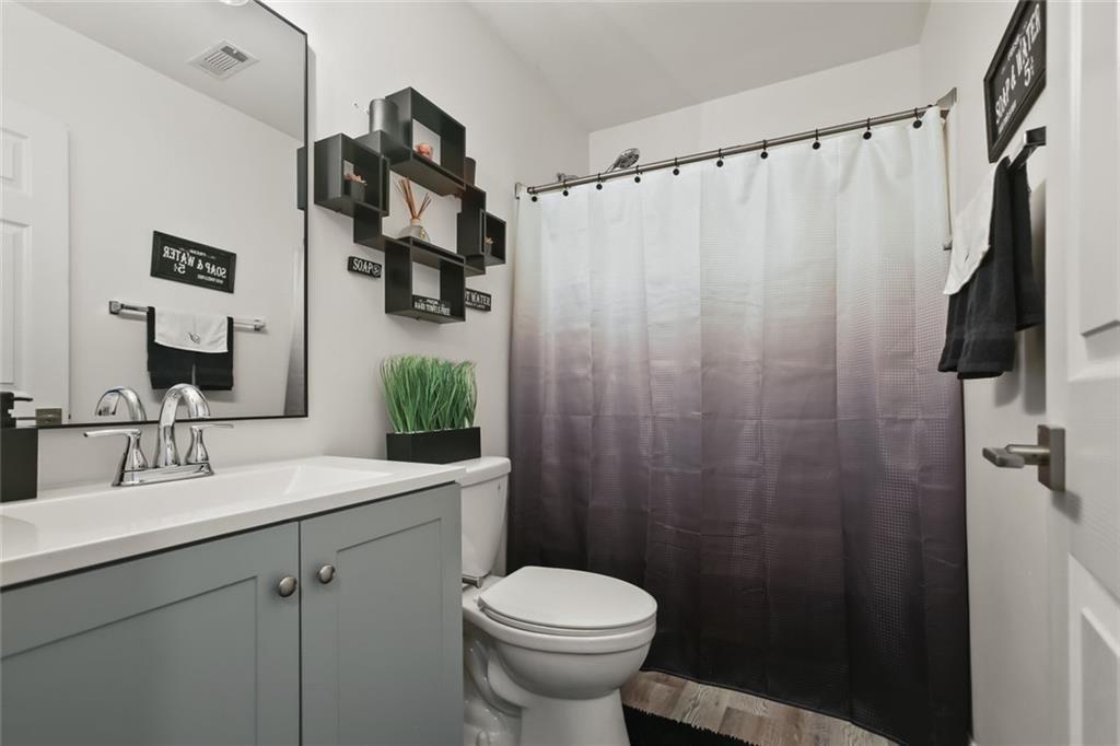 1464 Gates Circle Southeast Atlanta, GA 30316 - Photo 18 of 26 a bathroom with a sink toilet and shower