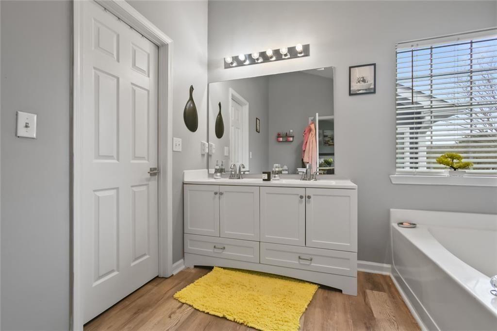1464 Gates Circle Southeast Atlanta, GA 30316 - Photo 24 of 26 a bathroom with a tub sink and mirror