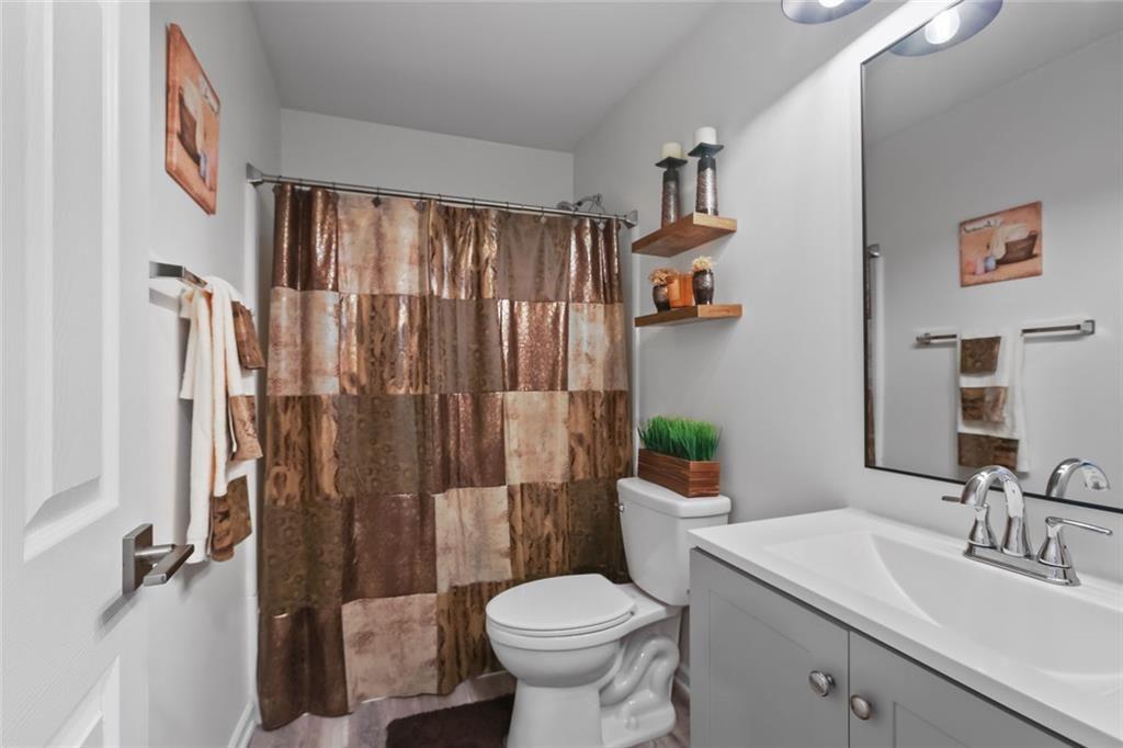 1464 Gates Circle Southeast Atlanta, GA 30316 - Photo 6 of 26 a bathroom with a sink toilet and shower