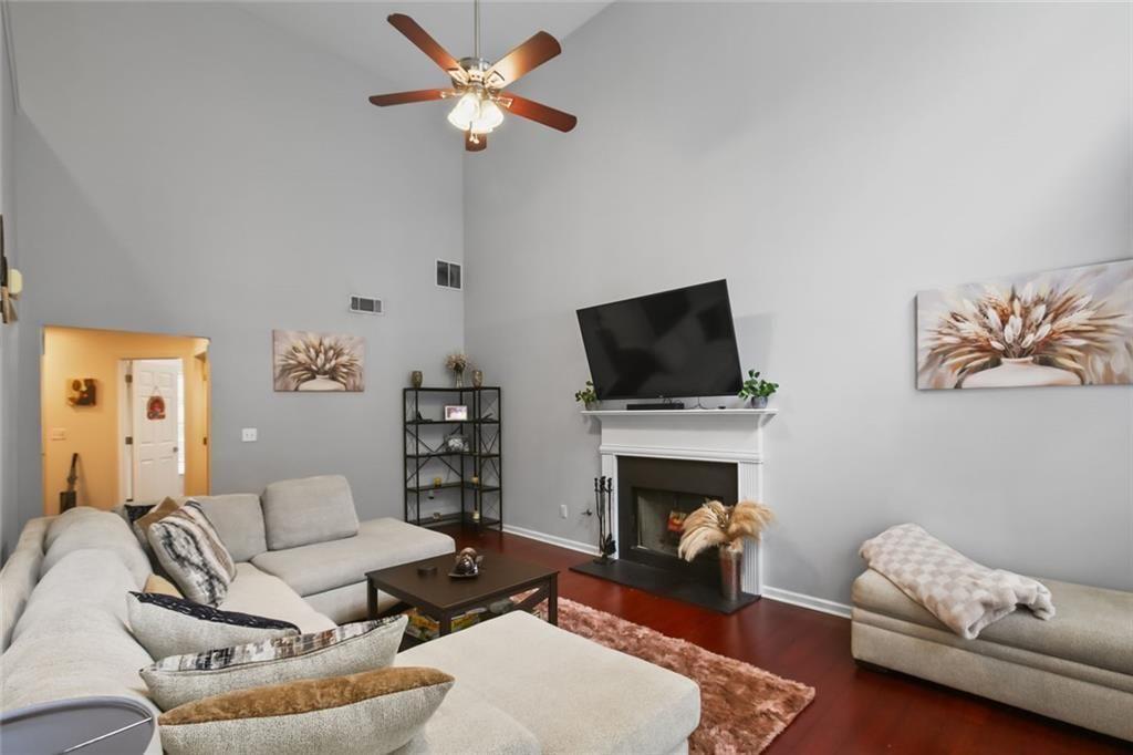 1464 Gates Circle Southeast Atlanta, GA 30316 - Photo 10 of 26 a living room with furniture a fireplace and a flat screen tv